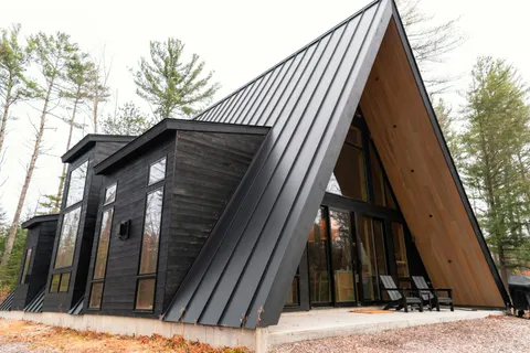 Modern A-frame home with metal roof installation by Everstead Roofing